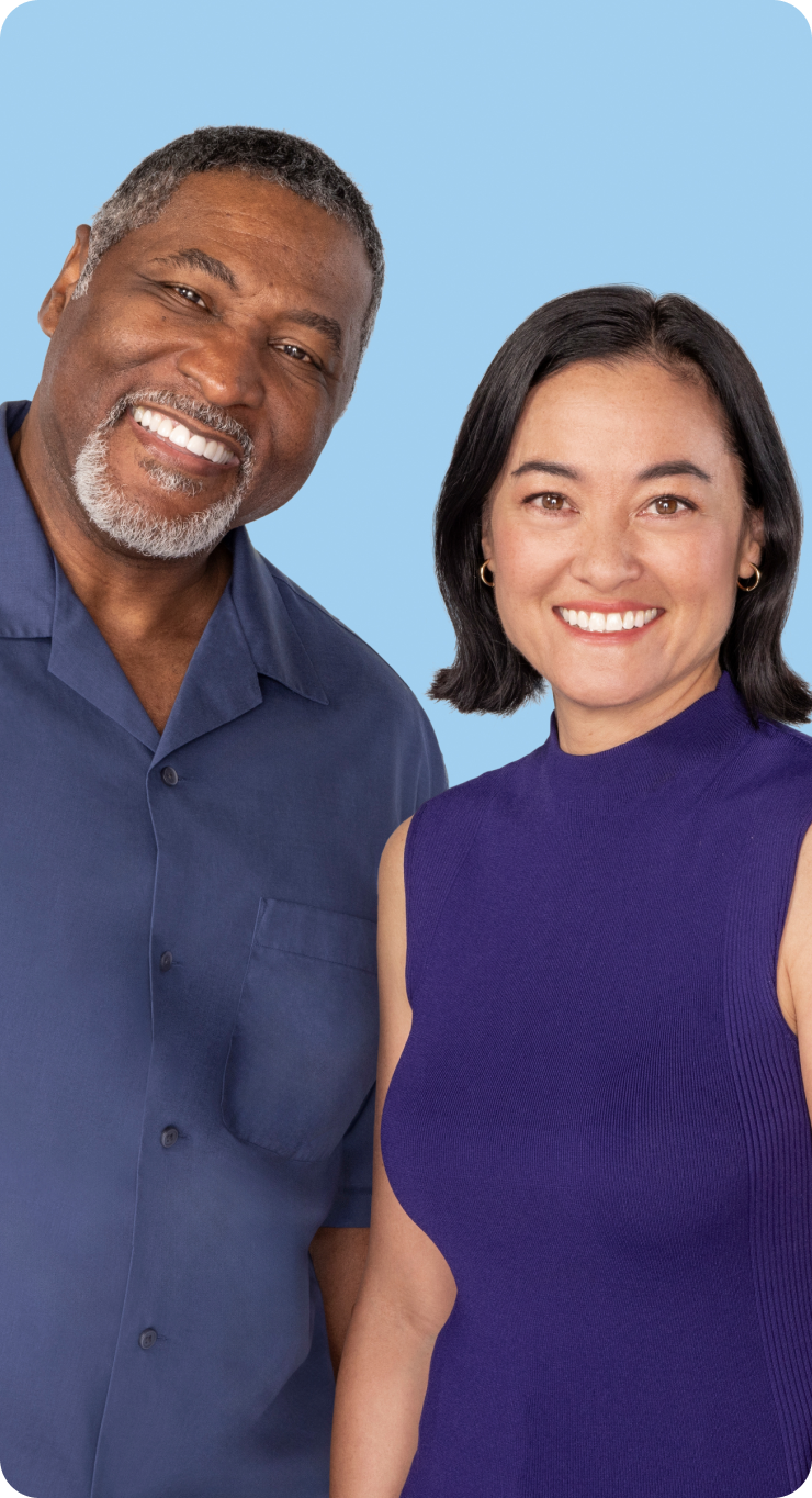 Man and woman standing next to each other smiling