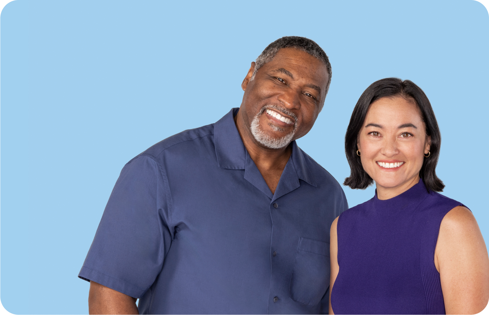 Man and woman standing next to each other smiling